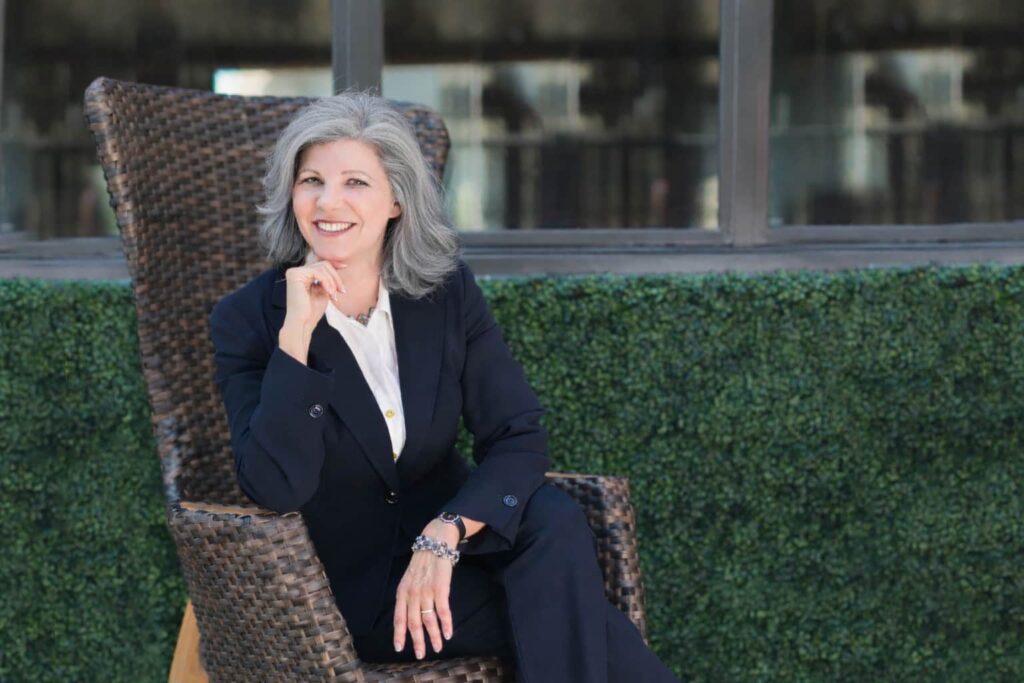 Edith Hamilton - Executive Coach sitting in chair portrait mode